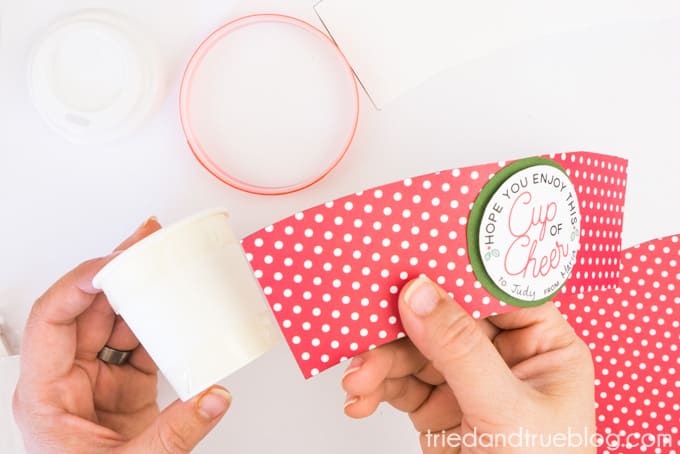 Wrapping the free Mini Coffee Cup Christmas Gift wrapper around the cup.