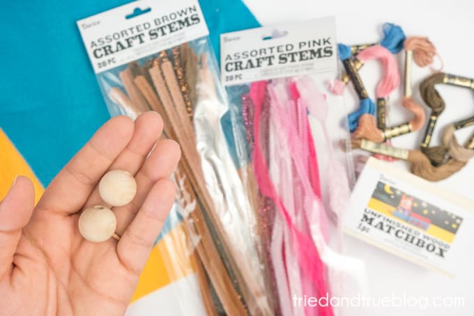 Supplies needed to make project including pipecleaners, embroidery floss, craft felt, and wood beads.