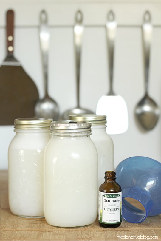 Three large mason jars with homemade body wash and a jar of glycerin.