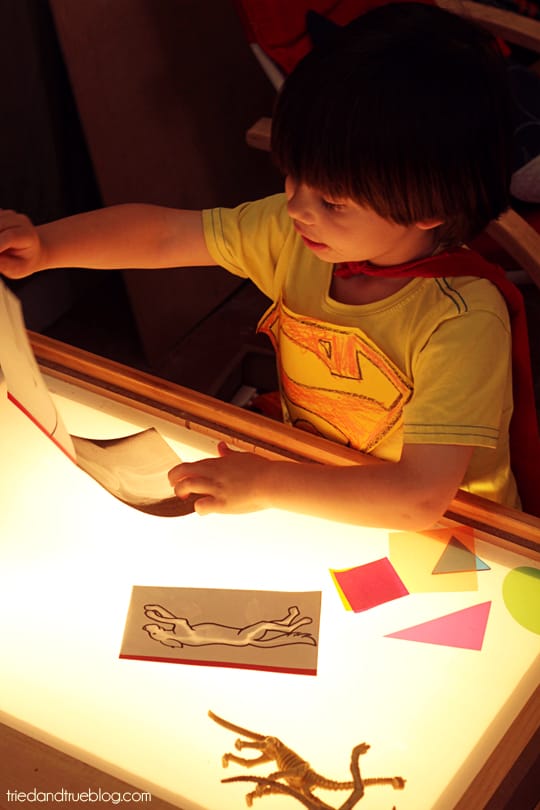 Child using play x-rays on a light table.