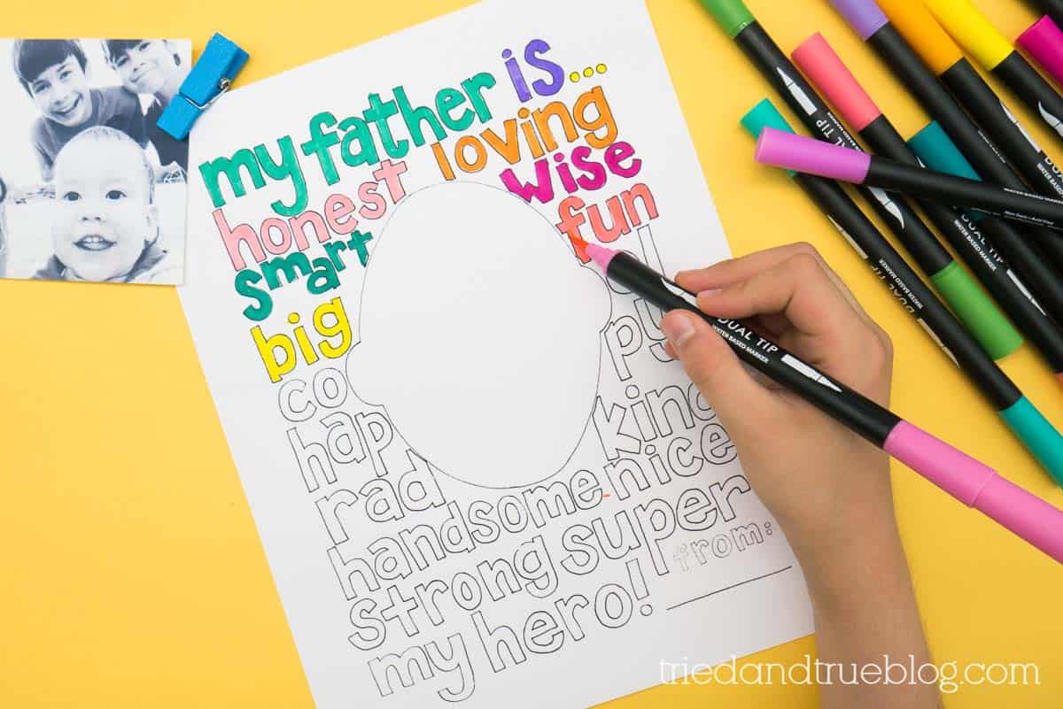 Child's hand coloring in the Free Father's Day Coloring Page with markers.
