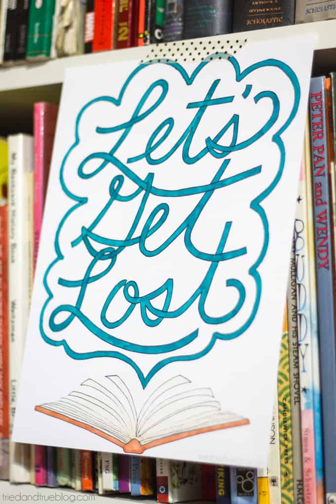 Book Lovers Coloring Page with the hand-drawn words, "Let's Get Lost," hanging on a shelf of books.