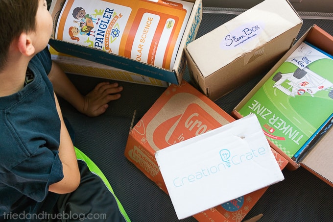 Child looking inside of the Steve Spangler subscription box for kids.