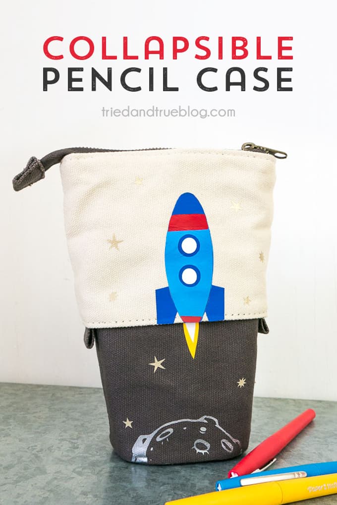 Collapsible Pencil Case with image of rocket ship and moon on it.