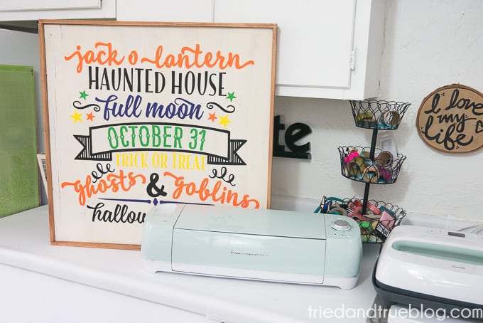 Cricut Explore Air 2 on a counter with the Reversible Halloween & Thanksgiving Sign