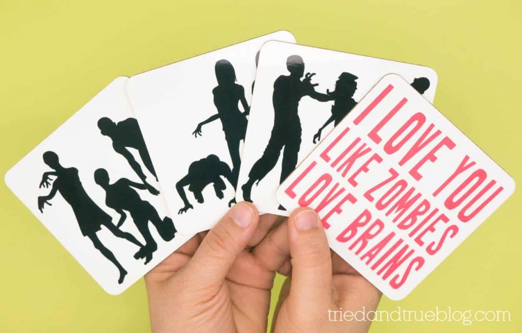 Hand Holding Zombie Coasters made with Infusible Ink. 