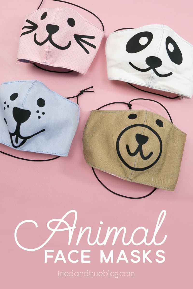 Four cloth face masks with animal faces on the front of them.