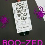 Wine bottle with Cute You've Been Boo-zed Label on a black background.