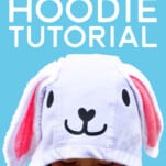 Girl wearing Easter Bunny Hoodie on blue background