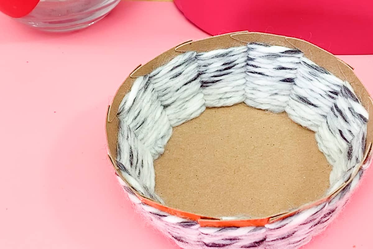 Cardboard Basket Weaving basket on pink background