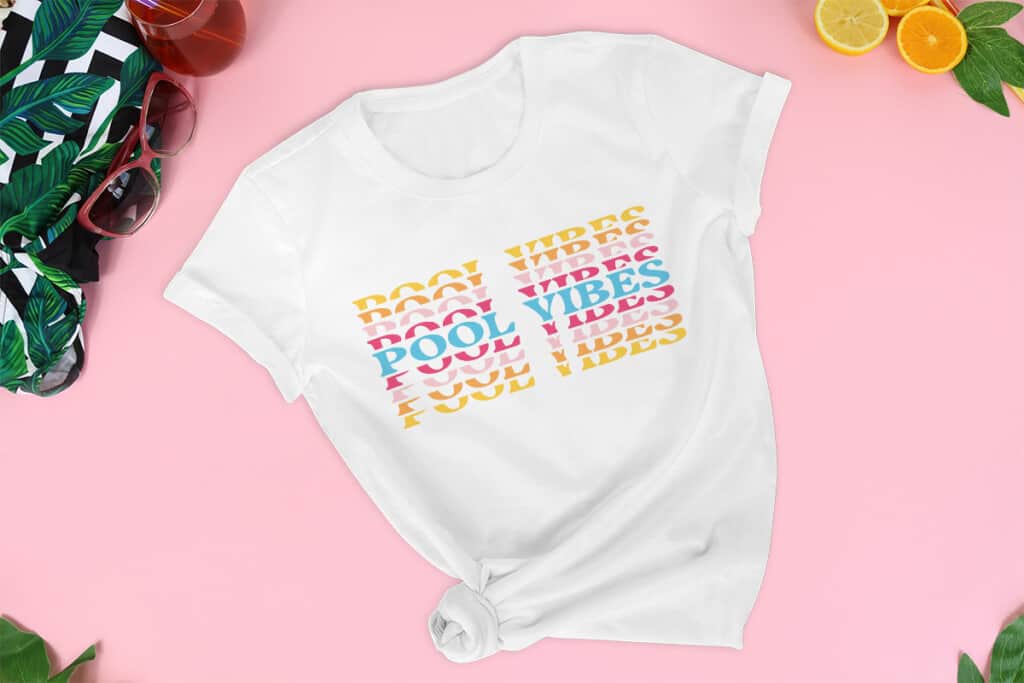 White tshirt with the Summer Vibes SVG Free Files on it that says "Pool Vibes" on pink background