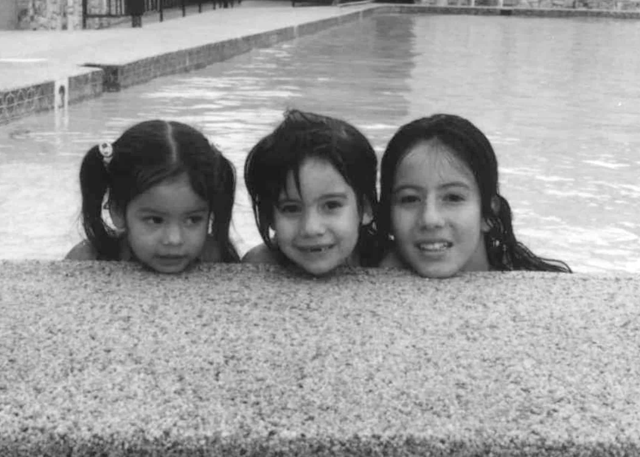 Old picture of three little girls by a pool