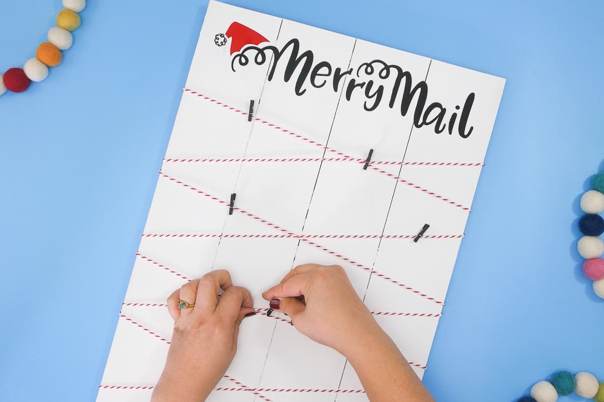 A person is making a merry mail board.