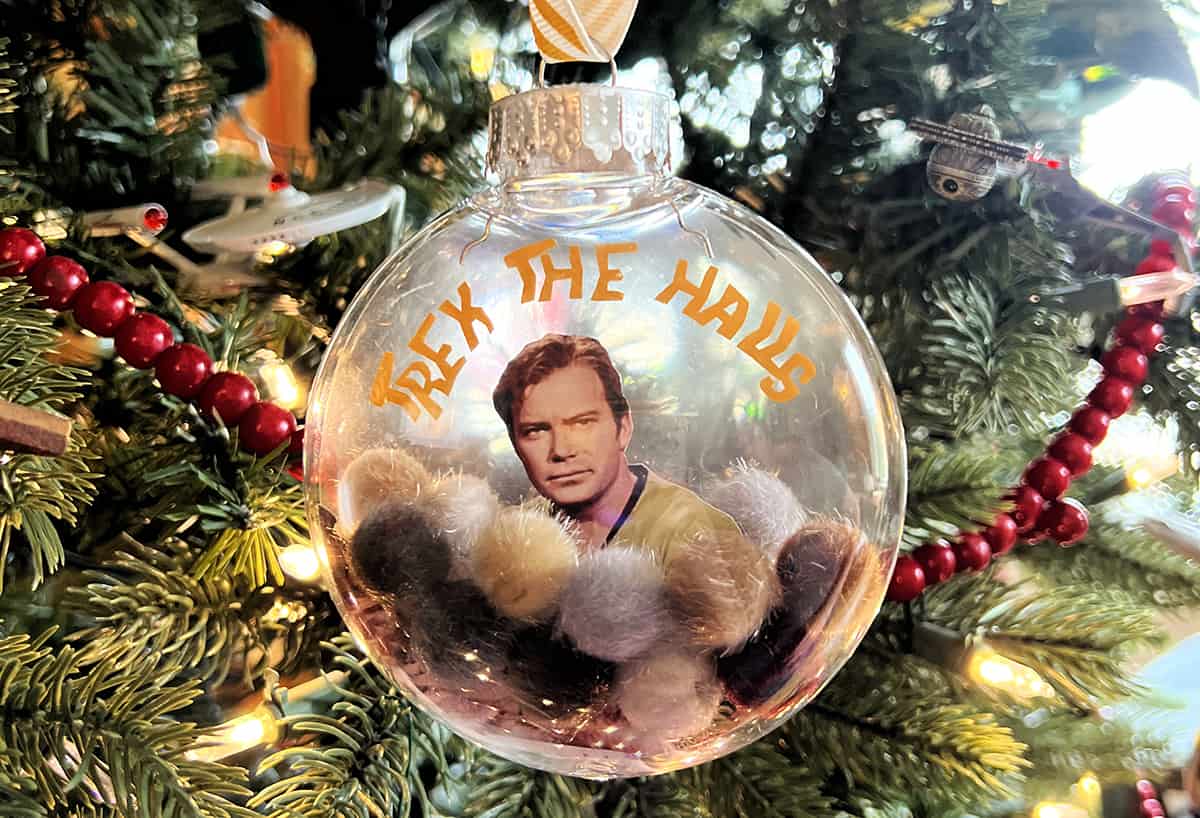 A christmas ornament with a picture of a star trek tribbles and Capt. Kirk