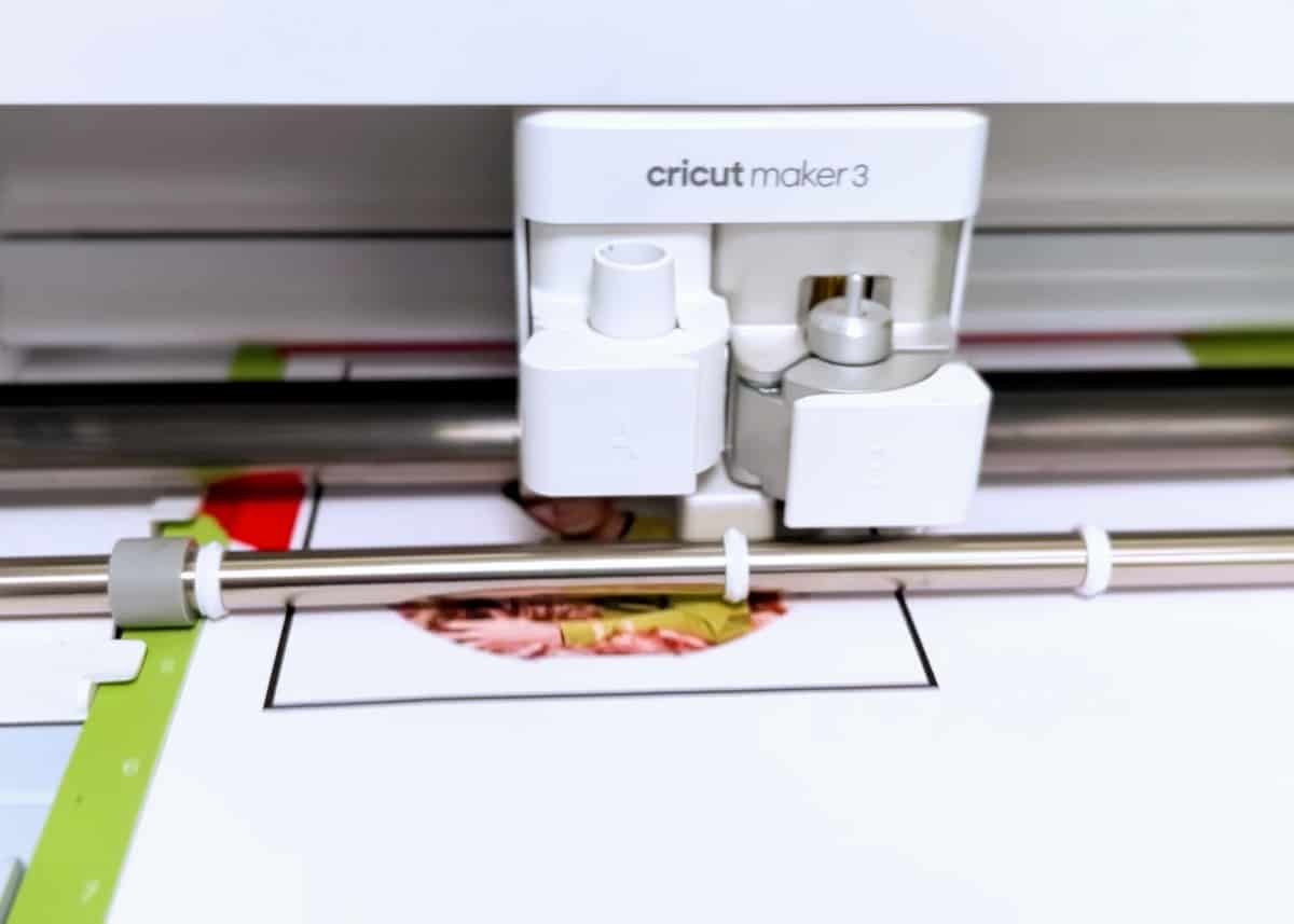 A cricut machine is being used to cut a piece of paper.