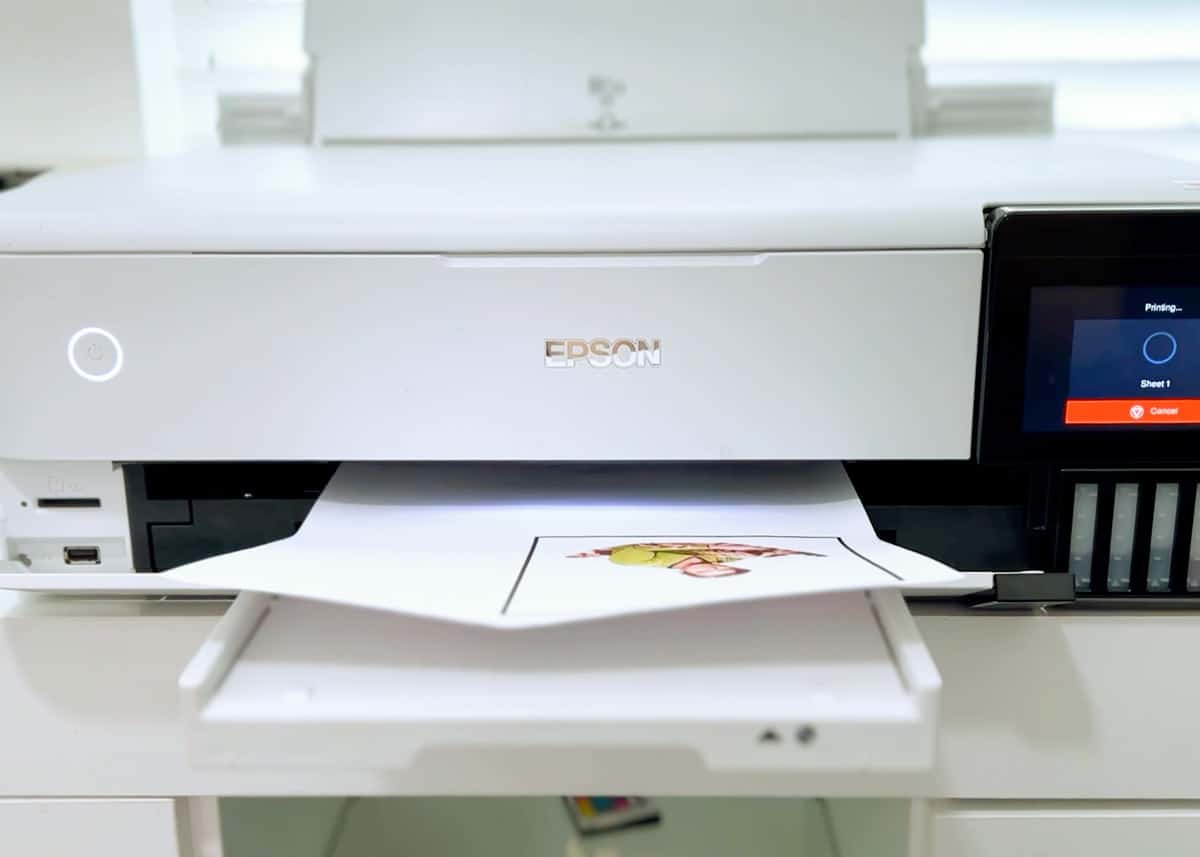 An epson printer is sitting on top of a desk.