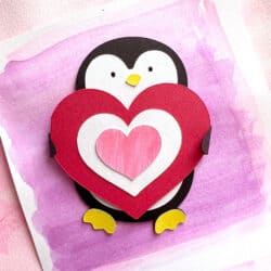A penguin holding a heart on a pink background.