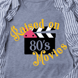 T-shirt with a film clapperboard graphic and the text "Raised on 80's Movies," surrounded by a striped button-up shirt.